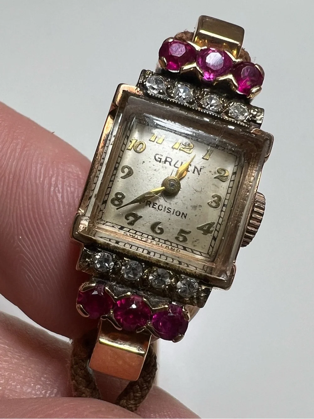 Gruen Precision wristwatch crafted in 14k rose gold with rubies and diamonds